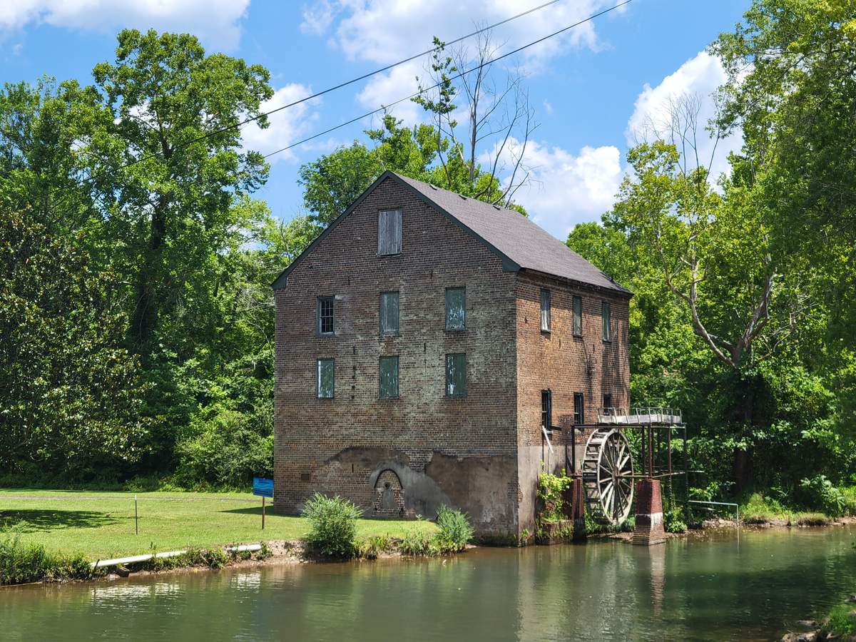 Historic old brick mill with a water wheel in Lindale, Georgia